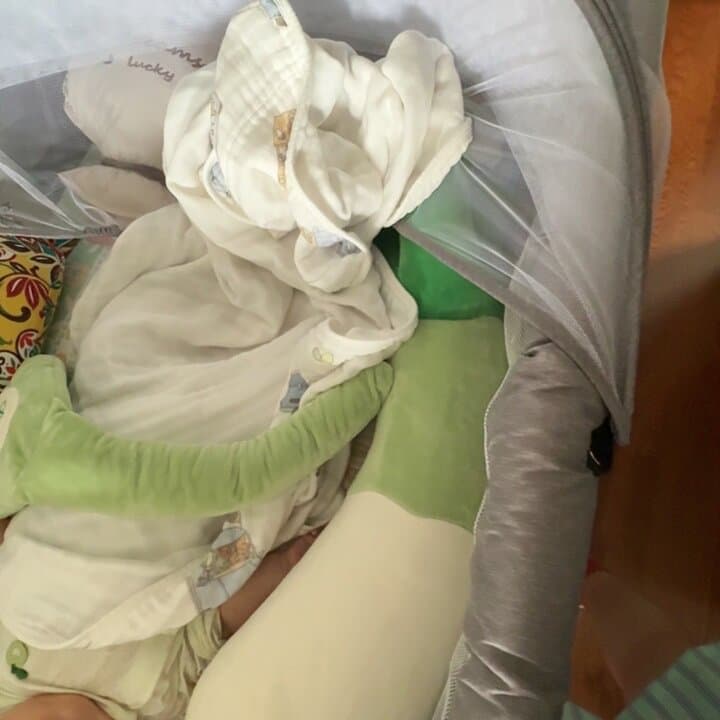 Parent photo: baby settled in a cot with the Dile Sleep Companion